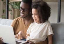 Five Tech Savvy Tips for Safe Streaming Smiling father and daughter viewing laptop.