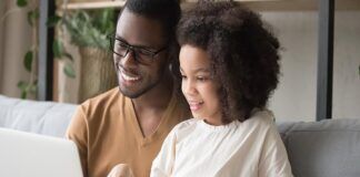 Five Tech Savvy Tips for Safe Streaming Smiling father and daughter viewing laptop.