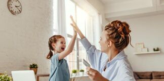 Protect Your Family with These Six Safe Streaming Tips young girl and mother high five in front of laptop