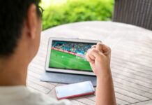 Is It Illegal to Stream Live Sports on Twitch? Legal Risks Explained Man streaming a soccer match on his tablet while at home