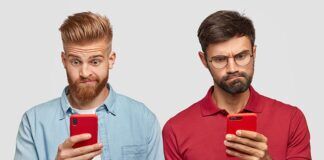 Watching Pirated Content is Not Safe Two adult males viewing mobile phone screens with confused looks.