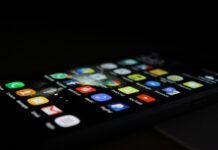 The Most Popular Illegal Movie Apps To Avoid A phone screen lighting up in the dark.