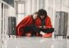 Is an Unsecured Public Wi-Fi Network Safe for Streaming? Two happy people in red waiting in airport with luggage sharing wifi on mobile device