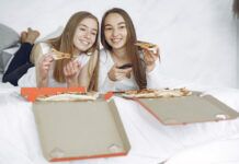 The Best Female-Lead TV Shows To Stream Right Now Two happy women with open pizza boxes enjoying a streaming tv movie.