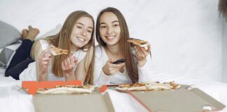 The Best Female-Lead TV Shows To Stream Right Now Two happy women with open pizza boxes enjoying a streaming tv movie.