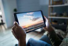 Streaming Devices: The Hacker’s Bullseye Person with outstretched legs streaming content on a tablet device