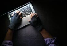 The Future of Piracy: How Illegal Streaming Will Change in the Coming Years person with black gloves on a laptop